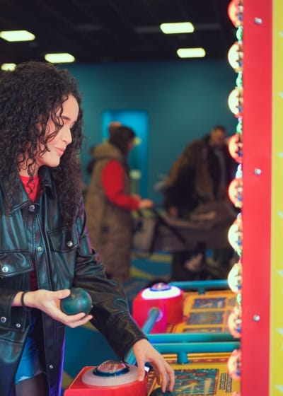 girl playing arcade games at fair girl playing arcade games at fair