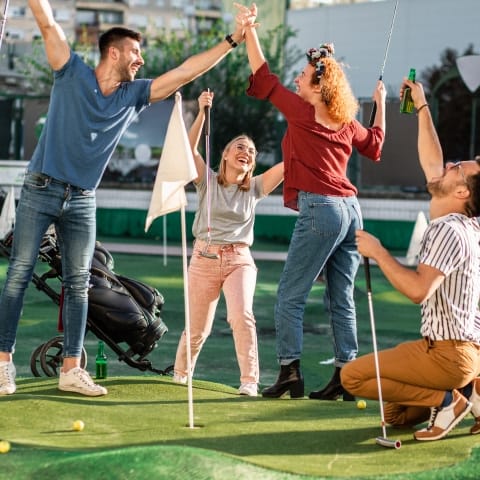 happy family playing mini golf outdoors party happy family playing mini golf outdoors party